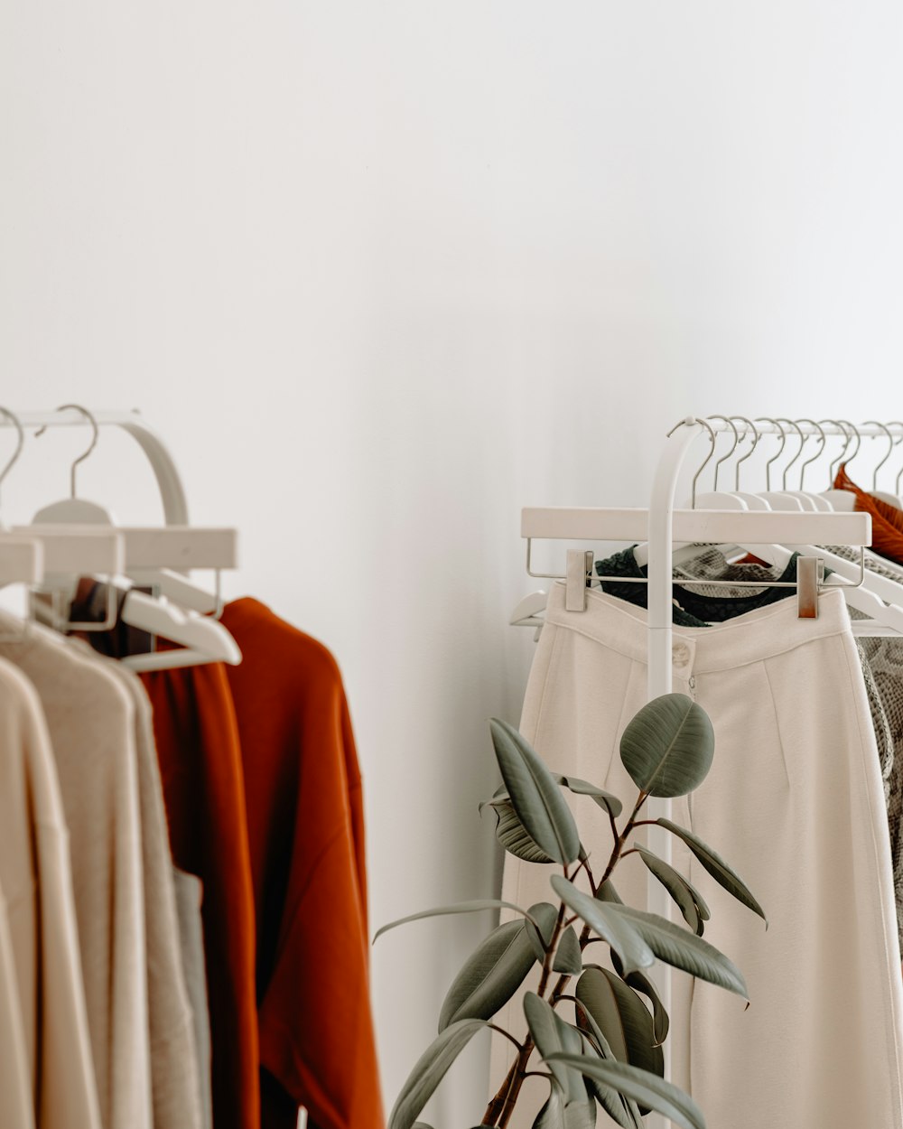 Neutral toned autumn clothing hanging on a boutique rail