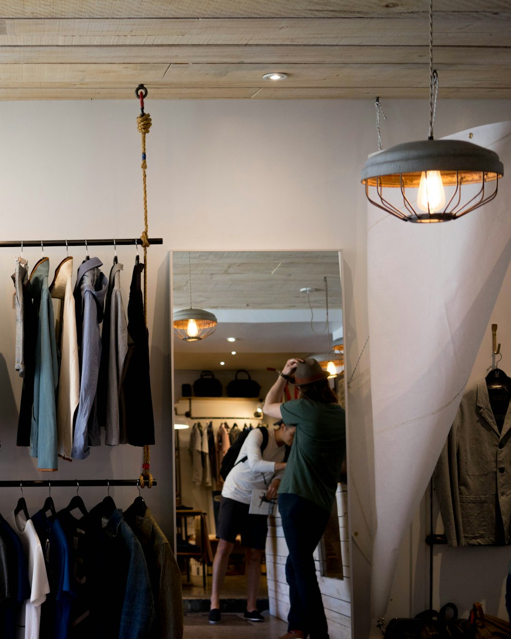 Interior of a boutique with clothing rails and warm lighting